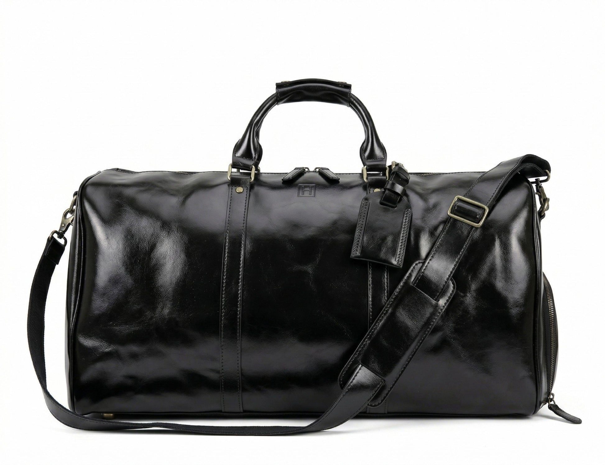Black leather duffel bag with shoulder strap on a white background