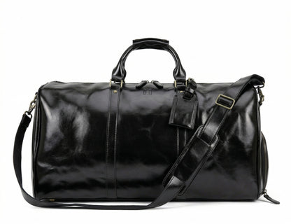 Black leather duffel bag with shoulder strap on a white background
