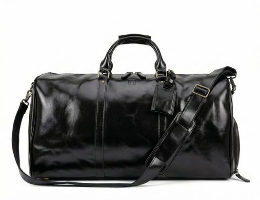 Black leather duffel bag with shoulder strap on a white background