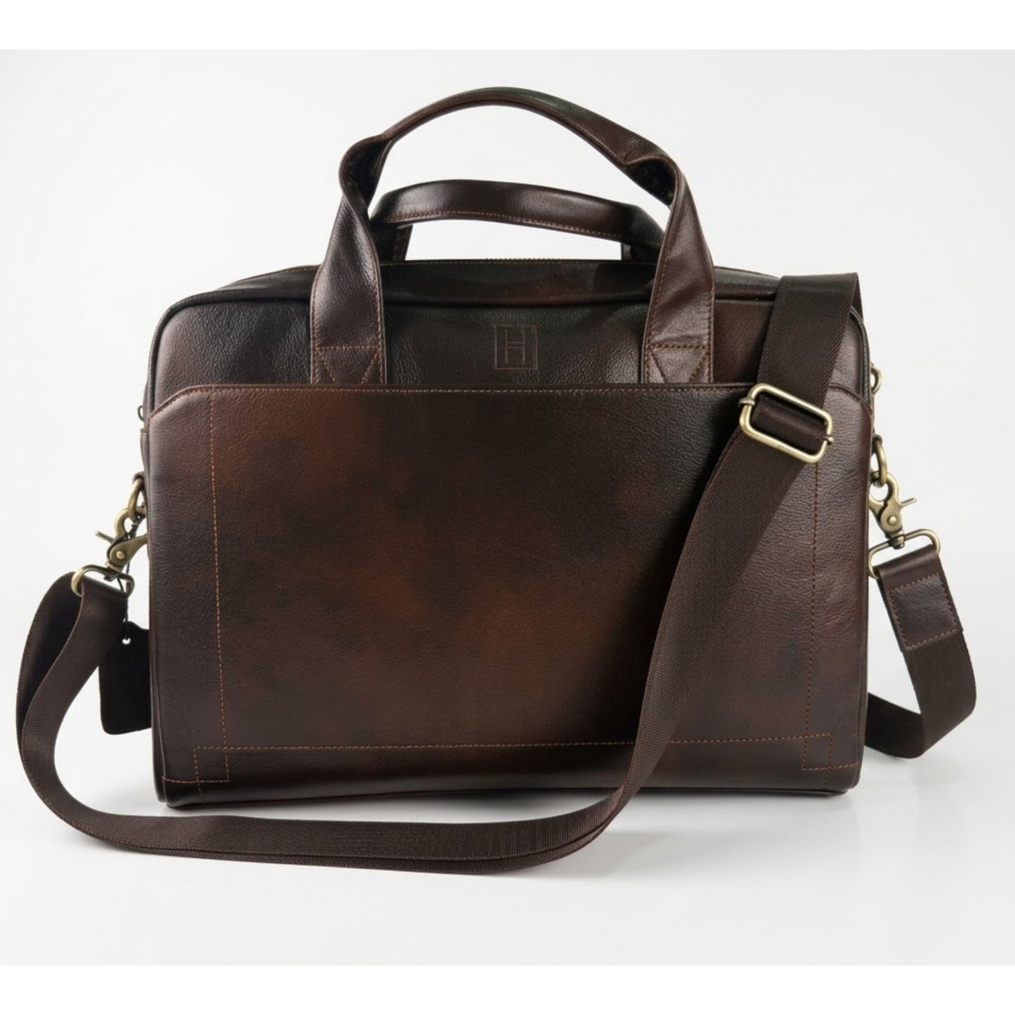 Brown leather briefcase with shoulder strap on a white background