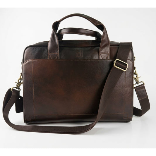 Brown leather briefcase with shoulder strap on a white background