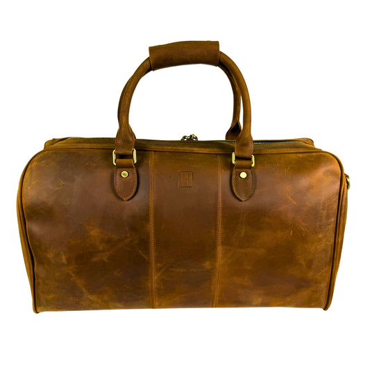 Brown leather duffel bag on a white background