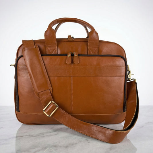 Brown leather briefcase with a shoulder strap on a white background