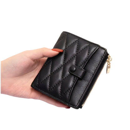 Black quilted wallet held by a hand on a white background