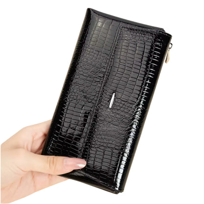 Black crocodile-patterned wallet held by a hand on a white background