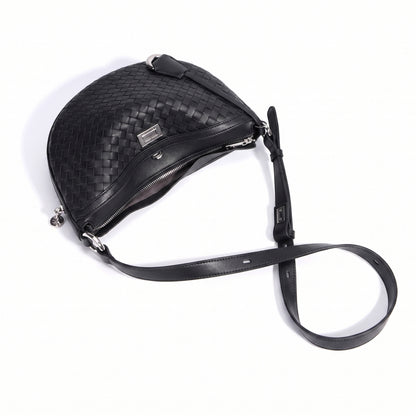 Black woven leather handbag with a strap on a white background