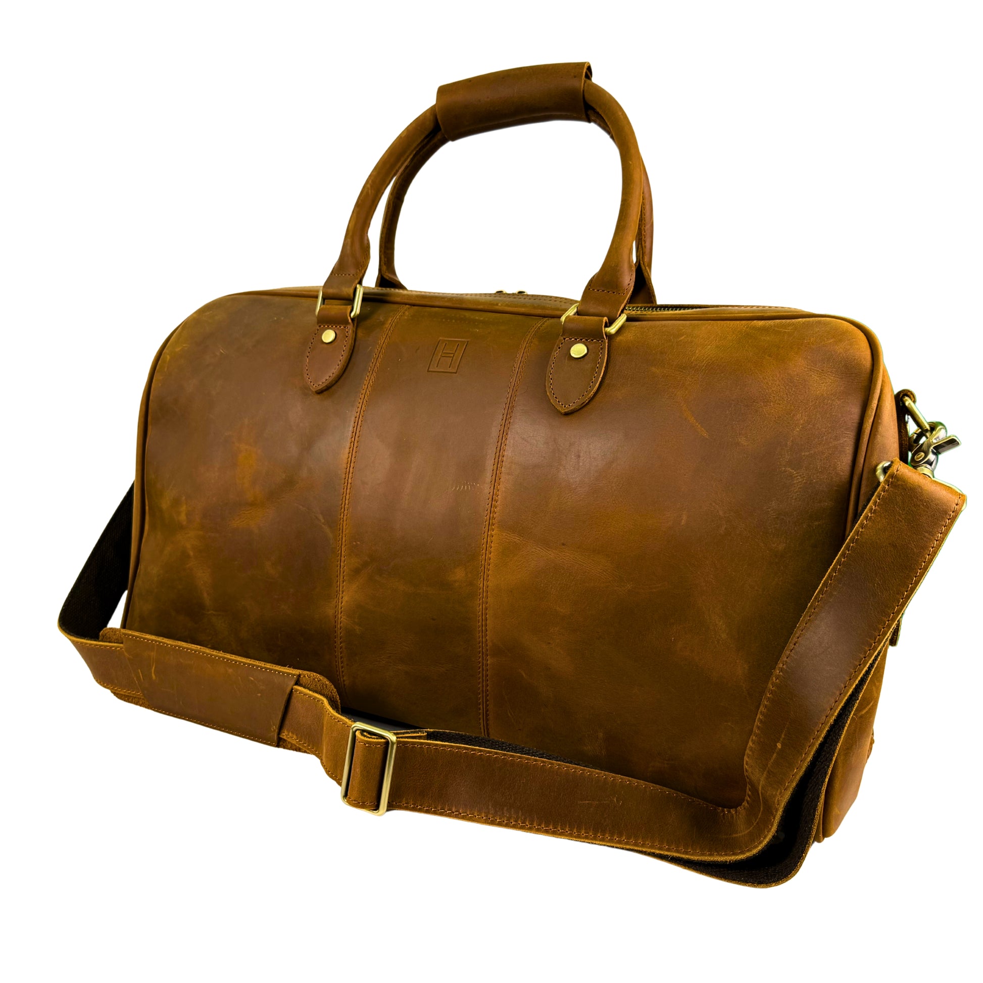 Brown leather duffel bag with shoulder strap on a white background