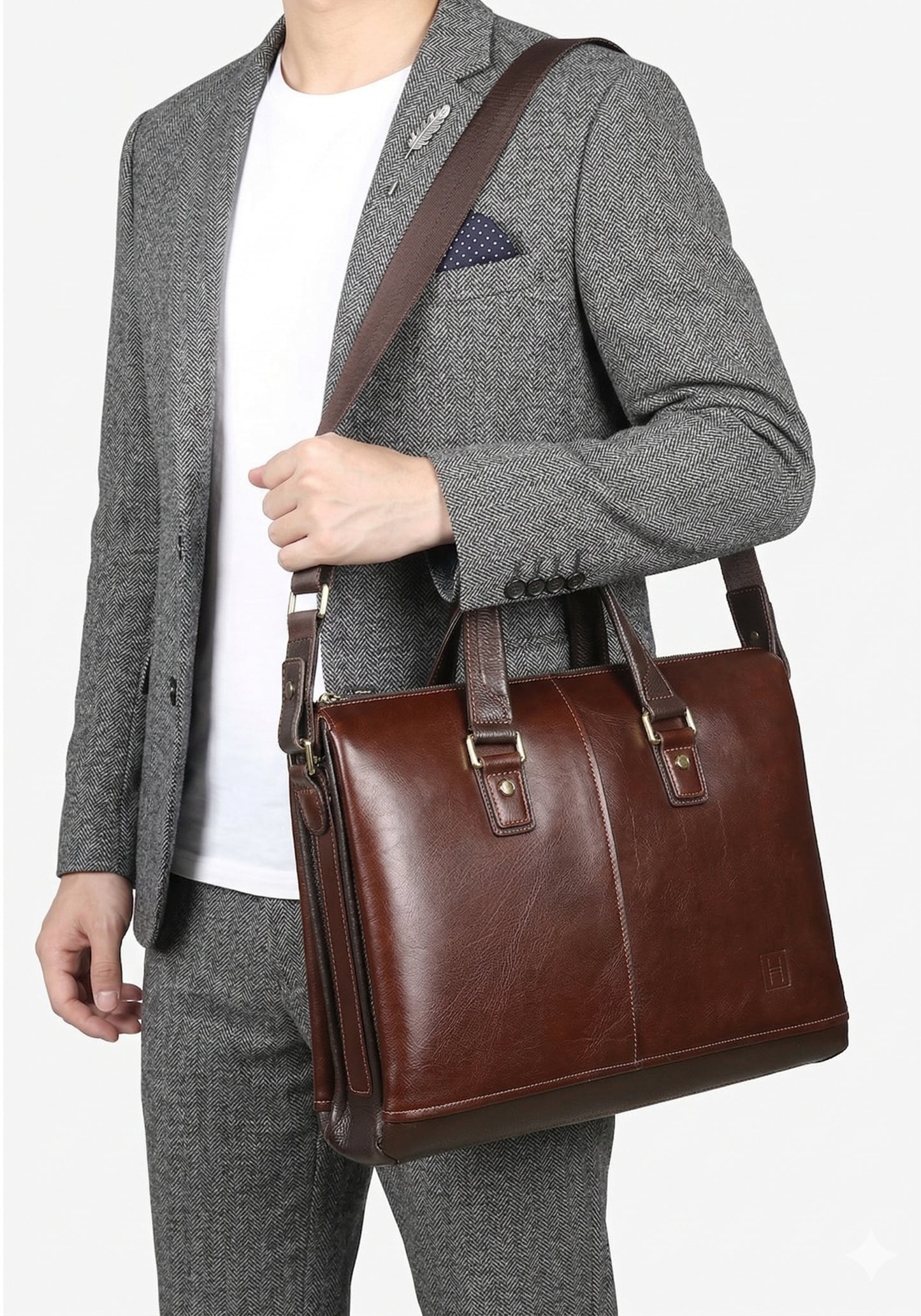 Person wearing a gray blazer and holding a brown leather briefcase on a white background