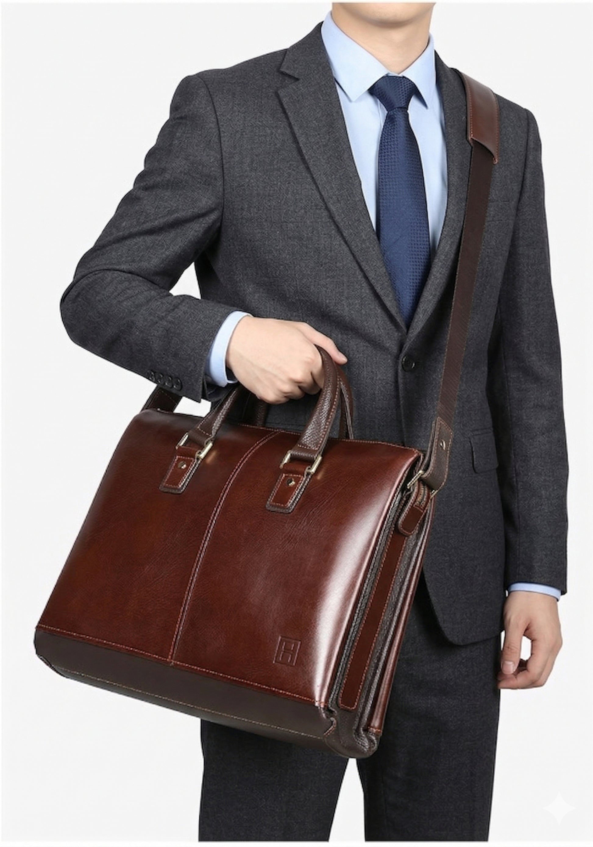 Man in a suit holding a brown leather briefcase against a white background