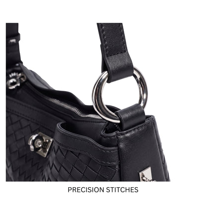 Close-up of a black handbag with precision stitching and a silver ring handle on a white background.