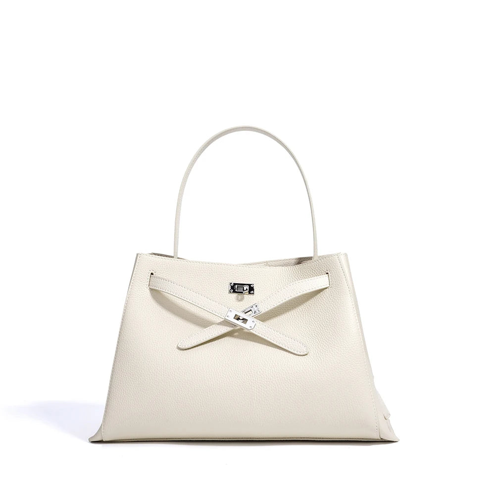 White handbag with a silver clasp on a white background