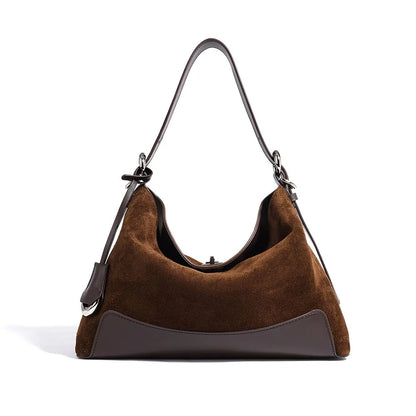 Brown handbag with a black strap on a white background