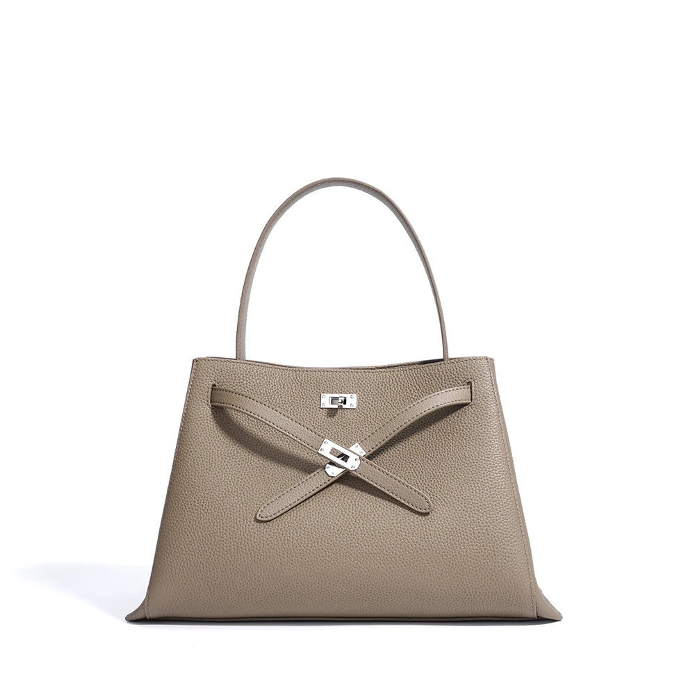 Beige handbag with a visible brand logo on a white background