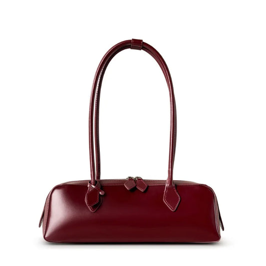 Red handbag with a bow on a white background